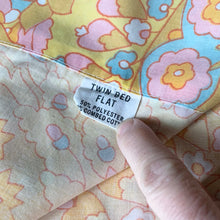 Load image into Gallery viewer, Vintage 1000 Nights poly cotton bed sheets featuring a bohemian geometric flower power design in shades of red, green, blue, pink, orange, yellow and white. Crafted by Dan River Mills, USA, 1970s. A beautiful addition to your retro boho bedding decor, or repurpose for crafting.
Both flat sheets are in excellent vintage condition, no stains/tears. The fitted sheet is in as found condition, loss of elasticity. Colours are vibrant.
Flat twin sheet measures 72 x 94 inches