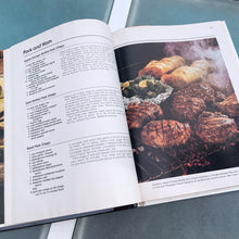 Load image into Gallery viewer, Better Homes and Gardens is known for its fabulous cookbooks. This hardcover cookbook focuses on their all time favourite barbecue inspired recipes. Its 96 pages are filled with amazing recipes along with many colour photographs. Originally published by Meredith Corporation, USA, 1977. This is the fourth printing 1984. In great vintage condition with normal age-related yellowing.