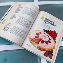 Load image into Gallery viewer, Better Homes and Gardens is known for its fabulous cookbooks. This hardcover cookbook focuses on its Pies and Cakes recipes. Its 90 pages are filled with amazing recipes along with many colour photographs. Originally published by Meredith Corporation, USA, 1966. This is the fifth printing, 1968. In great vintage condition with normal age-related yellowing.