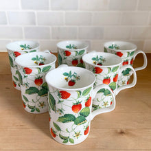 Load image into Gallery viewer, Six Roy Kirkham Alpine Strawberry bone china mugs arranged in a staggered group, angled overhead view showing botanical pattern inside and outside mugs with bumble bee detail visible