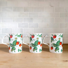 Load image into Gallery viewer, Side view of three Roy Kirkham Alpine Strawberry bone china mugs. displaying red strawberry and green leaf pattern
