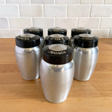 Load image into Gallery viewer, Vintage aluminum spice shaker with black lid featuring the name of the spice in white. Crafted by Kromex, USA, circa 1950s. A fabulous example of mid-century design and style! In vintage condition with age appropriate wear. Measures 2 1/4 x 4 inches