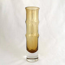 Load image into Gallery viewer, This vintage Bambu amber and clear bottom art glass vase is a prime example of iconic mid-century modern design. Designed by world–renowned artisan Bo Borgström in his inaugural year at Åseda Glasbruk, Sweden, 1961. A lovely vessel for a small floral bouquet and a great addition to a vintage art glass collection!
In excellent condition, no chips.
Measures 2 x 7 1/2 inches