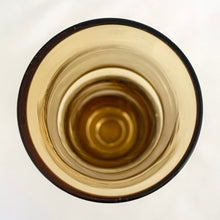 Load image into Gallery viewer, This vintage Bambu amber and clear bottom art glass vase is a prime example of iconic mid-century modern design. Designed by world–renowned artisan Bo Borgström in his inaugural year at Åseda Glasbruk, Sweden, 1961. A lovely vessel for a small floral bouquet and a great addition to a vintage art glass collection!
In excellent condition, no chips.
Measures 2 x 7 1/2 inches