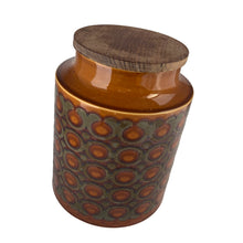 Load image into Gallery viewer, This highly sought after vintage amber and brown Bronte ceramic canister features a graphic repeating pattern of circles, dots and swirls. Designed by John Clappison for Hornsea Pottery, England, 1973. A great way to keep your kitchen decor looking stylish!
In excellent condition, no chips/cracks/repairs. Marked on the bottom, Hornsea England 1973 BRONTE.
Measures 6 x 7 3/4 inches