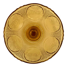 Load image into Gallery viewer, Antique Art Nouveau style amber pressed glass pedestal compote featuring 6 floral medallions, diamond star pattern on a thick pedestal and foot. Catalog number 1180. Crafted by Zabcowice Glassworks, Poland, 1910. This piece would look grand filled with fruit as a table centrepiece or fill with pine cones for display on your entranceway table....the decor possibilities are endless!
In excellent condition, no chips.
Measures 9 x 9 1/2 inches