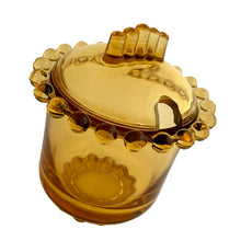 Load image into Gallery viewer, Vintage amber Party Line lidded glass marmalade jar or sugar bowl with a distinctive beaded edge. Crafted by Paden City Glass, USA, 1950s. A lovely addition to your tableware collection, or to give as a gift with a jar of your favourite condiment.
In very good condition, no chips, minor flea bites at the spoon hole.
Jar measures 3 1/2 x 3 3/4 inches
