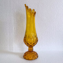 Load image into Gallery viewer, Glow in the dark elegance! Show off your daring style with this vintage mid-century "Moon and Stars" art glass swung vase that glows under black light. Crafted from amber glass with a striking moon and stars design, this American-made Kanawha Glass vase would be an unforgettable addition to any decor! In excellent condition, free from chips/cracks. Measures 3 1/2 x 12 1/8 inches