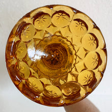 Load image into Gallery viewer, Glow in the dark elegance! Show off your daring style with this vintage mid-century "Moon and Stars" art glass swung vase that glows under black light. Crafted from amber glass with a striking moon and stars design, this American-made Kanawha Glass vase would be an unforgettable addition to any decor! In excellent condition, free from chips/cracks. Measures 3 1/2 x 12 1/8 inches