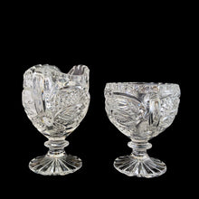 Load image into Gallery viewer, Elegant vintage American Brilliant Cut Glass Eleanor creamer and double handled open sugar. Crafted in the USA, early 20th century. These beauties are cut with an infinity pattern of diamond and cut leaves, crimped rims and sawtooth cut bottoms. Adds a touch of old world elegance to any tablescape.
In excellent condition, no chips.
Creamer measures 3 x 4 1/2 x 5 inches
Sugar measures 5 1/2 x 3 1/2 x 4 inches