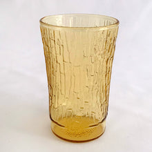 Load image into Gallery viewer, A charming set of four vintage mid-century modern honey gold "Pagoda" flat tumbler juice glasses made by the Anchor Hocking Glass Co. in the USA, circa 1960s-1970s. We love the distinct bark-like texture of this pattern. They're a perfect addition to any home! In excellent condition, no chips or cracks. Measures 2 3/8 x 3 3/4 inches Capacity 5 ounces