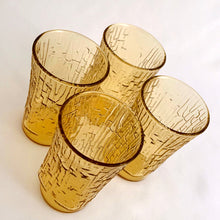 Load image into Gallery viewer, A charming set of four vintage mid-century modern honey gold "Pagoda" flat tumbler juice glasses made by the Anchor Hocking Glass Co. in the USA, circa 1960s-1970s. We love the distinct bark-like texture of this pattern. They're a perfect addition to any home! In excellent condition, no chips or cracks. Measures 2 3/8 x 3 3/4 inches Capacity 5 ounces