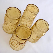 Load image into Gallery viewer, A charming set of four vintage mid-century modern honey gold "Pagoda" flat tumbler juice glasses made by the Anchor Hocking Glass Co. in the USA, circa 1960s-1970s. We love the distinct bark-like texture of this pattern. They're a perfect addition to any home! In excellent condition, no chips or cracks. Measures 2 3/8 x 3 3/4 inches Capacity 5 ounces