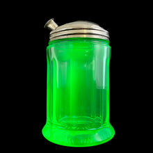 Load image into Gallery viewer, RARE FIND!
Antique uranium green depression glass sugar dispenser with chrome lid. Paden City Glass, USA, 1915. Lid by Elite Works Brass. The glass glows brilliantly under black light. A stunning piece of vintage history to add to your glass collection...a real gem!
In good vintage condition, no chips, minor flea bites around the collar where the lid meets the glass and age-related wear to the lid.
3 3/8 x 5 1/2 inches