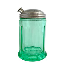 Load image into Gallery viewer, RARE FIND!
Antique uranium green depression glass sugar dispenser with chrome lid. Paden City Glass, USA, 1915. Lid by Elite Works Brass. The glass glows brilliantly under black light. A stunning piece of vintage history to add to your glass collection...a real gem!
In good vintage condition, no chips, minor flea bites around the collar where the lid meets the glass and age-related wear to the lid.
3 3/8 x 5 1/2 inches