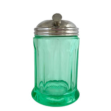 Load image into Gallery viewer, RARE FIND!
Antique uranium green depression glass sugar dispenser with chrome lid. Paden City Glass, USA, 1915. Lid by Elite Works Brass. The glass glows brilliantly under black light. A stunning piece of vintage history to add to your glass collection...a real gem!
In good vintage condition, no chips, minor flea bites around the collar where the lid meets the glass and age-related wear to the lid.
3 3/8 x 5 1/2 inches