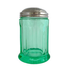 Load image into Gallery viewer, RARE FIND!
Antique uranium green depression glass sugar dispenser with chrome lid. Paden City Glass, USA, 1915. Lid by Elite Works Brass. The glass glows brilliantly under black light. A stunning piece of vintage history to add to your glass collection...a real gem!
In good vintage condition, no chips, minor flea bites around the collar where the lid meets the glass and age-related wear to the lid.
3 3/8 x 5 1/2 inches