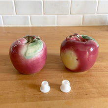 Load image into Gallery viewer, Sweet vintage mid-century era majolica style figural ceramic red apple salt and pepper shakers featuring brown branch and green leaves. Crafted by Metroware, Japan, circa 1940s. Perfect for adding kitsch style to your kitchen and table decor! In excellent used vintage condition, free from chips and new corks. Measures 2 3/8 x 2 1/4 inches