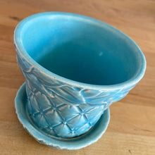 Load image into Gallery viewer, Vintage Art Deco aqua blue Tierra Cushion planter with attached underplate. Crafted by McCoy Pottery, 1950. This rare piece is must for any art pottery collector! A lovely way to enhance your home's decor or give as a gift!
In excellent vintage condition, no chips/cracks/repairs. Typical age-related crazing, manufacturer's glaze pops. Maker's marks.
Measures 4 x 3 3/8 inches