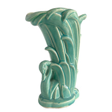 Load image into Gallery viewer, Beautiful vintage Swan vase glazed in gloss aqua, features a swan swimming in the reeds. Crafted by McCoy Pottery, 1948. This vase is must for any art pottery collector!
In excellent vintage condition, no chips, no cracks, no repairs. Minor manufacturer's defects, see photos. Maker's mark on the bottom.
Measures 6 7/8 x 4 1/8 x 9 1/4 inches