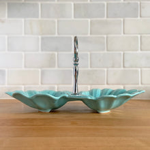 Load image into Gallery viewer, Vintage mid-century era aqua lotus leaf 2-part divided candy dish with silver-toned ring handle. Crafted by California Pottery, USA, 1950s. A lovely serving piece for nuts, candies....whatever you fancy!
In excellent condition, no chips/cracks/repairs. Reinforced handle with new rubber washer.
Measures 10 3/4 x 6 x 1 3/4 inches (6 1/4 inches with handle)