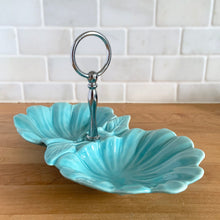 Load image into Gallery viewer, Vintage mid-century era aqua lotus leaf 2-part divided candy dish with silver-toned ring handle. Crafted by California Pottery, USA, 1950s. A lovely serving piece for nuts, candies....whatever you fancy!
In excellent condition, no chips/cracks/repairs. Reinforced handle with new rubber washer.
Measures 10 3/4 x 6 x 1 3/4 inches (6 1/4 inches with handle)
