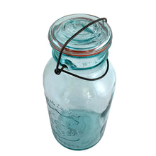 Load image into Gallery viewer, Vintage Perfect Seal aqua glass mason jar,featuring glass lid and wire bail closure. Produced by the Hamilton Glass Works in the early 20th century. These jars are fabulous for storing dry goods or may be repurposed as a vase. Perfect for farmhouse and cottage core decor. In as found condition. Measures 4 1/2 x 9 1/2 inches Capacity 2 quarts (1/2 gallon)