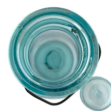 Load image into Gallery viewer, Vintage Perfect Seal aqua glass mason jar,featuring glass lid and wire bail closure. Produced by the Hamilton Glass Works in the early 20th century. These jars are fabulous for storing dry goods or may be repurposed as a vase. Perfect for farmhouse and cottage core decor. In as found condition. Measures 4 1/2 x 9 1/2 inches Capacity 2 quarts (1/2 gallon)