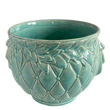 Load image into Gallery viewer, Large vintage TIerra Cushion jardiniere planter pot, aqua gloss glaze, features an overlapping floral leaf pattern around the top rim, a diamond quilted body and ribbon handles. Crafted by McCoy Pottery, USA, 1950s. A must-have for any McCoy collector or gardener!
In excellent condition, free from chips, cracks or repairs, with a manufacturer's defect at the rim, see photo. Maker's mark is on the bottom.
Measures 8 3/4 x 7 1/2 inches