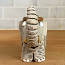 Load image into Gallery viewer, Artesania Rinconada elephant figurine number 9 vintage Uruguay pottery front view segmented trunk ivory tusks white eyes brown ribbed saddle crown collectible art pottery
