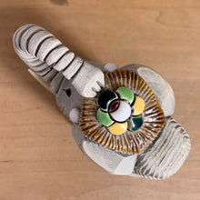 Load image into Gallery viewer, Artesania Rinconada elephant figurine number 9 overhead view multicolour glazed flower medallion saddle green yellow black white red petals handmade Uruguay pottery detail