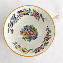 Load image into Gallery viewer, Vintage hand painted, multi-colour Asian rose flowered teacup in the Chinoiserie style is a rare pattern produced by Hammersley and Company, Bone China, England, circa 1940s. Painted in the interior and exterior, the flowers are shades of blue, pink, yellow and green featuring a pair of scrolls tied with a pink bow. Makes a lovely gift for any occasion. Excellent condition, free from chips, cracks or repairs. Teacup measures3 1/2 x 2 1/4 inches. Saucer measures 5 1/4 inches