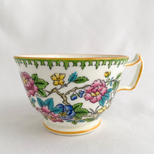 Load image into Gallery viewer, Vintage hand painted, multi-colour Asian rose flowered teacup in the Chinoiserie style is a rare pattern produced by Hammersley and Company, Bone China, England, circa 1940s. Painted in the interior and exterior, the flowers are shades of blue, pink, yellow and green featuring a pair of scrolls tied with a pink bow. Makes a lovely gift for any occasion. Excellent condition, free from chips, cracks or repairs. Teacup measures3 1/2 x 2 1/4 inches. Saucer measures 5 1/4 inches
