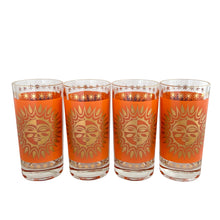 Load image into Gallery viewer, Close-up of four vintage Celestial Aztec Sun highball glasses showing detailed orange geometric sun face pattern with 22K gold rim and base decoration