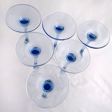 Load image into Gallery viewer, Bottom view of six vintage Luminarc Azur champagne flutes with pale blue stems and clear bowls, Cristal d'Arques-Durand France, 1991-2006, arranged showing elegant French crystal design
