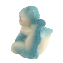 Load image into Gallery viewer, Vintage baby boy ceramic planter, shape 92. This sweet planter features a baby boy in blue diaper holding a rattle, leaning against a blue ruffled edged pillow. Crafted by Hull Pottery, USA, 1950s. Perfect for a houseplant or to use as nursery decor or as a practical holder for baby's accessories. In excellent condition, no chips. Measures 5 1/4 x 4 1/2 x 5 1/2 inches