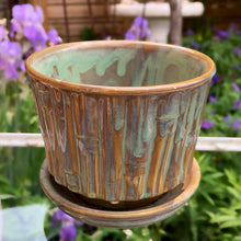 Load image into Gallery viewer, Vintage blended exotic brown glazed Bamboo ceramic planter with attached saucer from the Green Thumb Line. Crafted by McCoy Pottery, 1970s. A hard-to-find planter in a rare glaze. A must have for any art pottery collector. A sweet piece for your favourite houseplant or succulent.
In excellent vintage condition, no chips/cracks/repairs, typical age-related crazing and manufacturer's glaze pops. Maker's marks.
Measures 5 1/2 x 4 1/2 inches