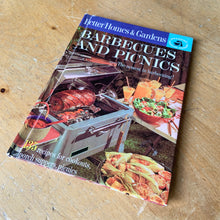 Load image into Gallery viewer, Better Homes and Gardens is known for its fabulous cookbooks. This hardcover cookbook focuses on barbeque and picnic inspired recipes. Its 61 pages are filled with amazing recipes along with many colour photographs. Originally published by Meredith Corporation, USA, 1963. This is the first edition. In great vintage condition with normal age-related yellowing.