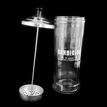 Load image into Gallery viewer, Originally created by a science teacher, this fantastic vintage Barbicide pressed glass canister jar has been the trusted vessel for holding germicide and disinfectant for over 75 years! These jars are in every barber and hair stylists shops to disinfect scissors, combs and other hair care tools. Use as intended or repurpose to hold straws for a fun diner vibe! Measures 4 1/4 x 11 inches. Marked "King Research Inc. 4754 Made in Canada". Capacity of 32 ounces