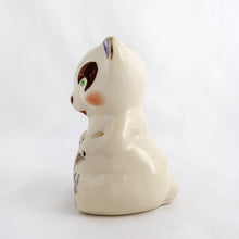 Load image into Gallery viewer, Adorable vintage miniature hand painted bear figurine featuring rosy cheeks, pink floral decals and gold gilt accents on a cream ground. Crafted by Shawnee Pottery, circa 1950s. This wee figurine is one of those rare, hard-to-find pieces that will make a delightful addition to your home's decor....perfect for a child's nursery!