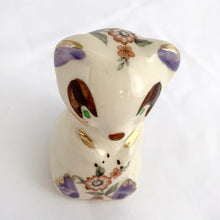 Load image into Gallery viewer, Adorable vintage miniature hand painted bear figurine featuring rosy cheeks, pink floral decals and gold gilt accents on a cream ground. Crafted by Shawnee Pottery, circa 1950s. This wee figurine is one of those rare, hard-to-find pieces that will make a delightful addition to your home's decor....perfect for a child's nursery!