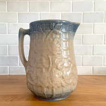 Load image into Gallery viewer, Vintage art deco gloss beige blue fade ceramic yellow ware pitcher featuring climbing roses on a trellis pattern. Crafted by McCoy Pottery, USA, 1920s. A beautiful piece to add to your art pottery collection!
In excellent condition, no chips/cracks/repairs, age-related crazing. Typical manufacturing glaze pops. Unmarked.
Measures 7 x 7 7/8 inches incl. handle