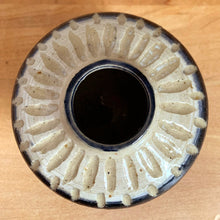 Load image into Gallery viewer, Overhead top-down view of Bennett studio pottery vase — full sunburst carving visible, elongated oval relief marks radiating around dark cobalt-rimmed opening, glossy cream glaze