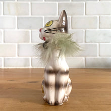 Load image into Gallery viewer, Super funky vintage anthropomorphic hand painted big yellow eyed striped cat ceramic figurine, sporting a fur collar and bell. Sticker indicates Ozark Souvenir, West Plains, MO. Crafted in Japan, 1950s. A great addition to your kitschy cat collection! In excellent vintage condition, no chips, minor wear to the red cold paint on the nose. Measures 2 1/4 x 1 5/8 x 4 3/4 inches