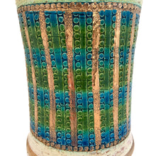 Load image into Gallery viewer, Vintage MCM art pottery footed vase with a band of repeating dots and stripes in shades of blue, green and gold on a pales butter yellow ground with gold details and green interior. Crafted by Bitossi Ceramiche, Italy 1960s. A wonderful piece of mid-century era art pottery to enhance your home's decor.
In good vintage condition, minor flea bit at the rim, no cracks or repairs. Sign on the bottom, 630 Italy.
Measures 6 x 12 3/4 inches