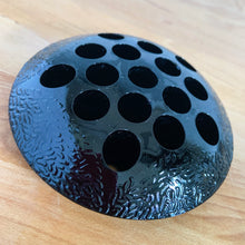 Load image into Gallery viewer, A rare vintage black amethyst glass flower frog with textured pattern and 16 holes. Crafted by the L. E. Smith Glass Company, USA, circa 1930s. When held up to a strong light, you'll be able to see the deep amethyst colour. Pair with your favourite vase or vessel to create a beautiful flower arrangement! In great condition, minor flea bites on several of the holes, see photos. Measures 4 1/2 x 1 inches