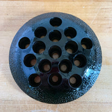 Load image into Gallery viewer, A rare vintage black amethyst glass flower frog with textured pattern and 16 holes. Crafted by the L. E. Smith Glass Company, USA, circa 1930s. When held up to a strong light, you'll be able to see the deep amethyst colour. Pair with your favourite vase or vessel to create a beautiful flower arrangement! In great condition, minor flea bites on several of the holes, see photos. Measures 4 1/2 x 1 inches