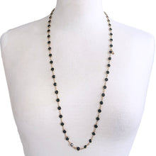 Load image into Gallery viewer, This stunning vintage opera-length necklace, features sparkly black faceted cut crystals set in gold-toned metal with branded tag. Crafted by Swarovski, Austria, 1980s. Wear it alone or paired with other vintage pieces for effortless glamour. A beautiful example of classic Swarovski craftsmanship, this piece offers luxury sparkle at a fraction of the cost of fine gemstones. Perfect for collectors, romantic outfits, or anyone who loves classic crystal jewelry with timeless appeal.