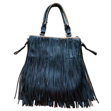 Load image into Gallery viewer, Vintage boho style black faux leather purse with fringe detail, tan interior with one zippered and two open pockets, snap closure. Crafted by Steve Madden.
In as found vintage condition with overall wear, interior is stained, see photos.
Measurements with handles 13 x 28 inches
Measurements without handles 13 x 16 1/2 inches