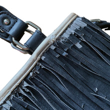 Load image into Gallery viewer, Vintage boho style black faux leather purse with fringe detail, tan interior with one zippered and two open pockets, snap closure. Crafted by Steve Madden.
In as found vintage condition with overall wear, interior is stained, see photos.
Measurements with handles 13 x 28 inches
Measurements without handles 13 x 16 1/2 inches